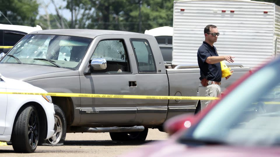 A law enforcement officer works the scene of the grocery store shooting on Friday. - Colin Murphey/Arkansas Democrat-Gazette/AP