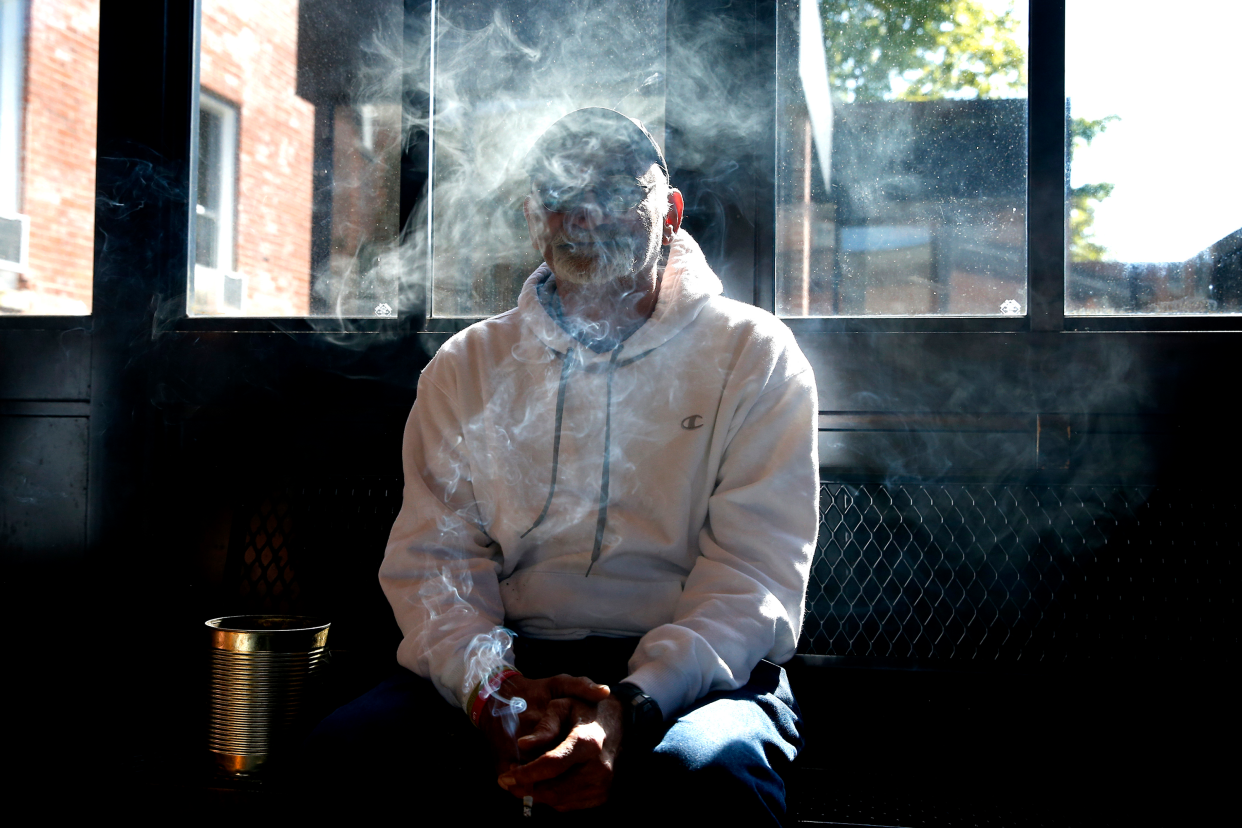 Navy Veteran Richard Negrin is enveloped in smoke inside the smoke shack at Soldier On in Leeds, MA on Sep. 19, 2019. (Jessica Rinaldi/The Boston Globe via Getty Images)