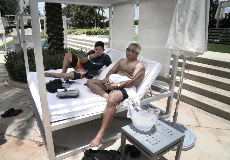 Naveen Reddy, right, and his son Kush enjoy the pool deck at Fontainebleau Miami Beach. The hotel reopened June 1, 2020 after having to shut down due to the coronavirus pandemic.