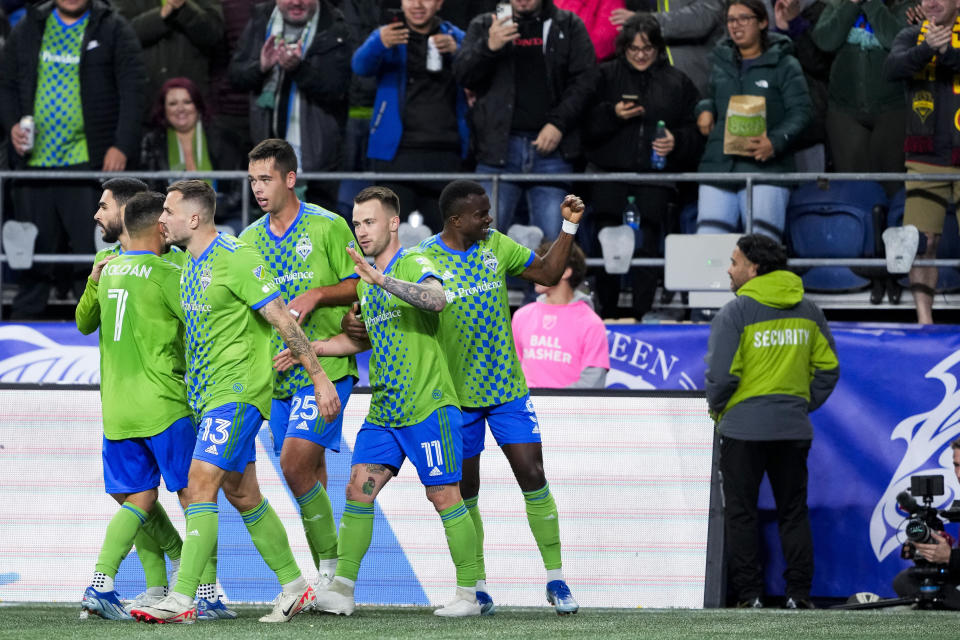 Seattle Sounders midfielder Albert Rusnák (11) celebrates after his goal against FC Dallas with teammates, including defender Nouhou Tolo, right, defender Jackson Ragen (25) and forward Jordan Morris (13), during the first half of Game 3 of a first-round playoff MLS soccer match Friday, Nov. 10, 2023, in Seattle. (AP Photo/Lindsey Wasson)