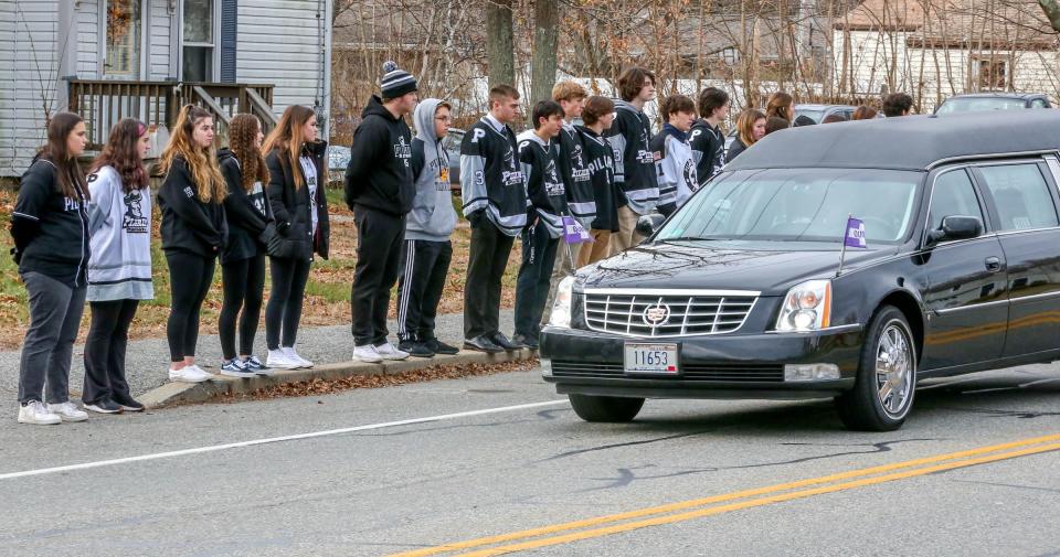 Pilgrim High School students line the street in front of St. Kevin Church as the funeral procession passes.