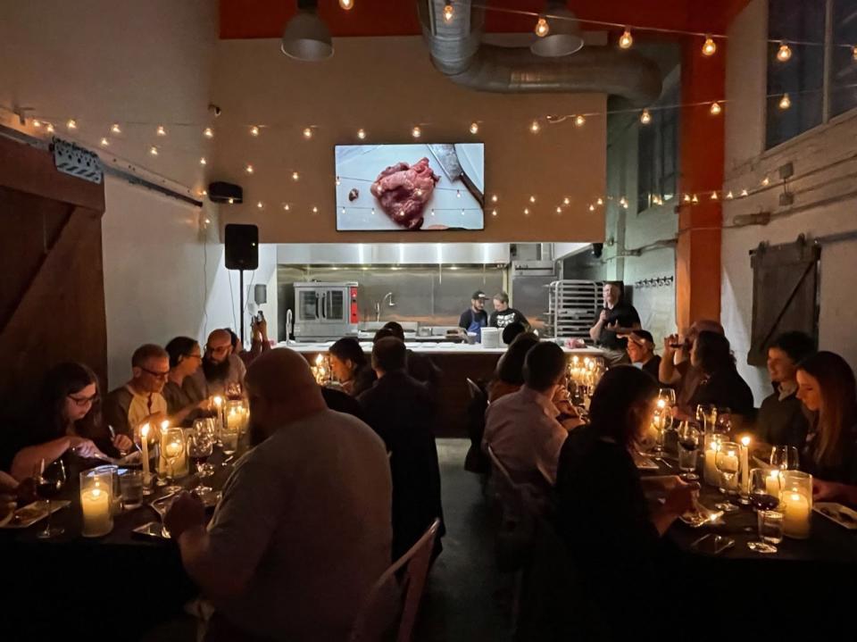 At a Washington, D.C. anatomy dinner a screen was set up so guests could watch Reisman dissect a cow heart while they dissected their own duck hearts, which were served on skewers. (Photo: Jonathan Reisman and Marcelle Afram)