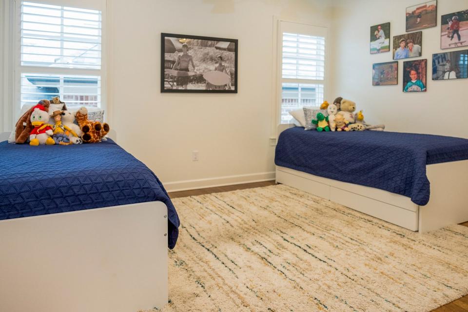 This upstairs guest room is for when their grandkids visit and features space-saving trundle beds.