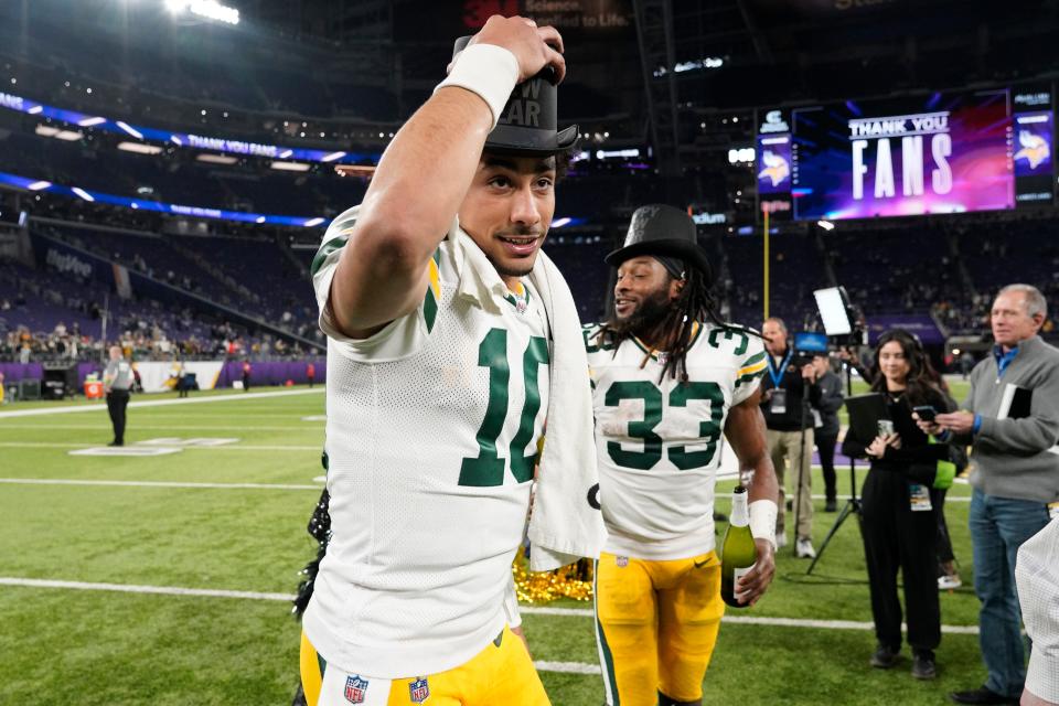 Jordan Love and Aaron Jones of the Green Bay Packers celebrate after a 33-10 victory against the Minnesota Vikings at U.S. Bank Stadium on Dec. 31, 2023, in Minneapolis, Minnesota.