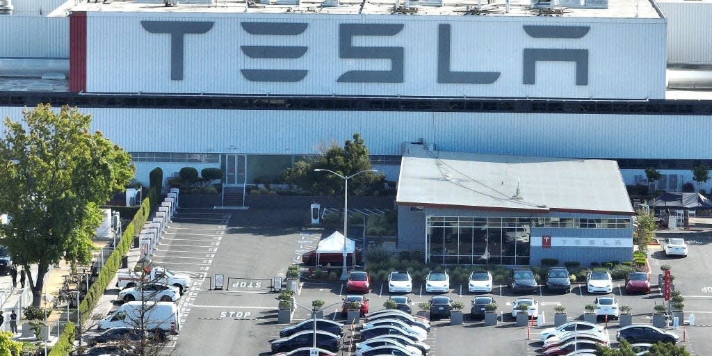 A parking lot outside a Tesla building.