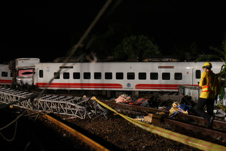 Rescuers search an overturned train in Yilan, Taiwan October 21, 2018. REUTERS/Lee Kun Han