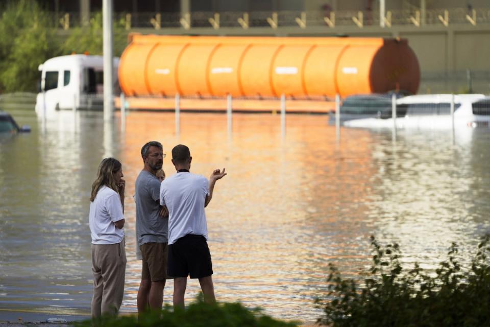 People look out at floodwater covering a major road in Dubai, United Arab Emirates, Wednesday, April 17, 2024 (Copyright 2024 The Associated Press. All rights reserved)