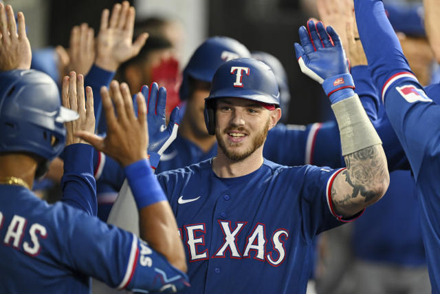 Texas Rangers' Jonah Heim runs the bases after a solo home run in