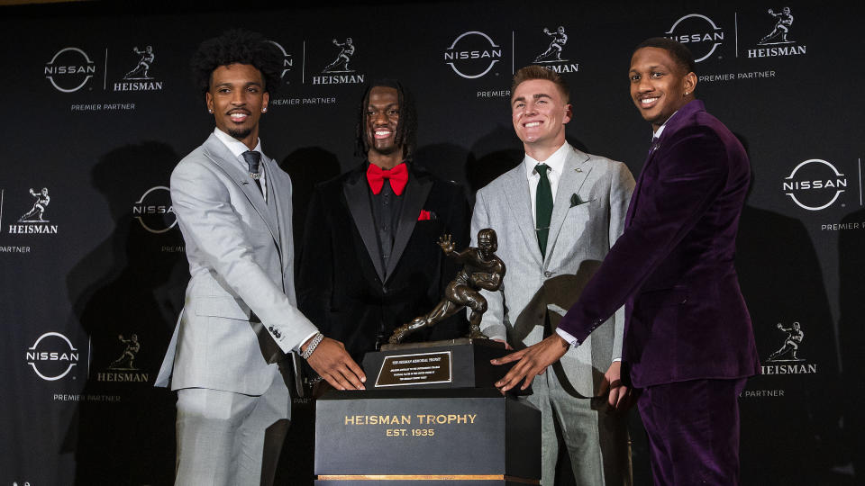 Heisman Trophy finalists, from left, LSU quarterback Jayden Daniels, Ohio State wide receiver Marvin Harrison Jr., Oregon quarterback Bo Nix and Washington quarterback Michael Penix Jr. pose with the trophy after attending a news conference before the award ceremony, Saturday, Dec. 9, 2023, in New York. (AP Photo/Eduardo Munoz Alvarez)