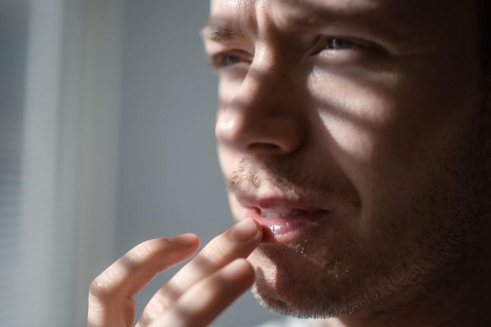 man applying moisturizing lip balm protection