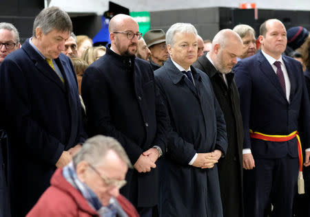 Belgium's Interior Minister Jan Jambon, Prime Minister Charles Michel, and Foreign Affairs Minister Didier Reynders attend a ceremony at the Maelbeek metro station to commemorate two years since bombings at Brussels airport and a metro station, in Brussels, Belgium March 22, 2018. Olivier Hoslet/Pool via REUTERS