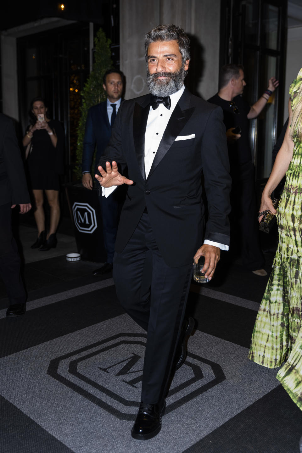 Oscar with a full beard, walking out and waving at fans