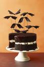 <p>For a simple way to Halloween-ify a basic layer cake, use festive bat toppers (these can be easily made with ribbon and wire!).</p><p> Get the <a href="https://www.goodhousekeeping.com/food-recipes/a5721/chocolate-pumpkin-cake-cupcakes-3922/" rel="nofollow noopener" target="_blank" data-ylk="slk:Chocolate Pumpkin Cake recipe;elm:context_link;itc:0;sec:content-canvas" class="link "><strong>Chocolate Pumpkin Cake recipe</strong></a><em>.</em></p>