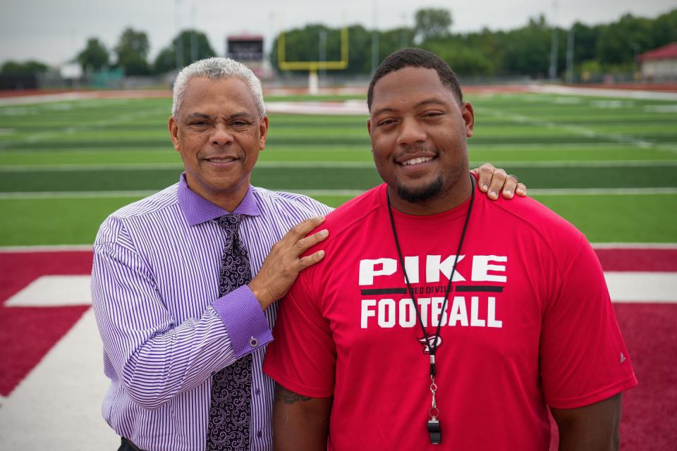 Pike football coach Michael Brevard (right) and Dennis Goins, director of Ben Davis Television and former coach, stand on the Pike football field for a photo Monday, Aug. 22, 2022. Goins has been a mentor and father figure to Brevard for 14 years, since the two met while Brevard was a student Ben Davis. “I’m so happy Mike got this job and took advantage of this opportunity. He wasn’t sure. It took him a while to make that decision because he’s a thinker and a listener. He didn’t want to put his family in jeopardy in any way," Goins said. "But now that he’s here, he’s going to turn this place around. He’s going to change the culture because of the experiences he’s had and this community is going to love him. All he needed is that chance.”