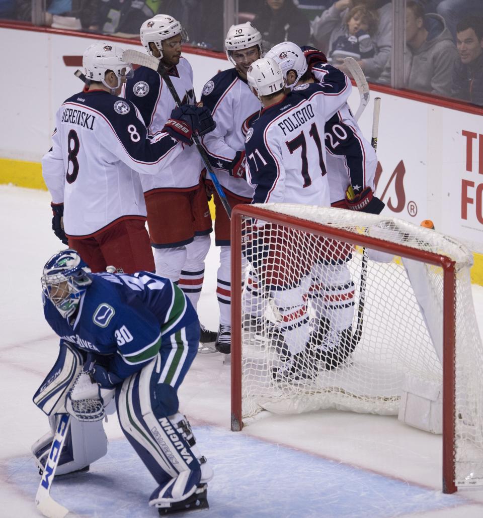 Columbus Blue Jackets left wing Brandon Saad (20) celebrates his goal past Vancouver Canucks goalie Ryan Miller (30) during the third period of an NHL hockey game, Sunday, Dec. 18, 2016 in Vancouver, British Columbia. (Jonathan Hayward/The Canadian Press via AP)