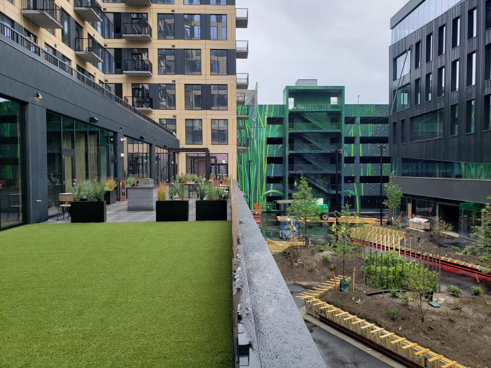 A deck on one of the apartment buildings in Gravity overlooks a common space (still under construction).