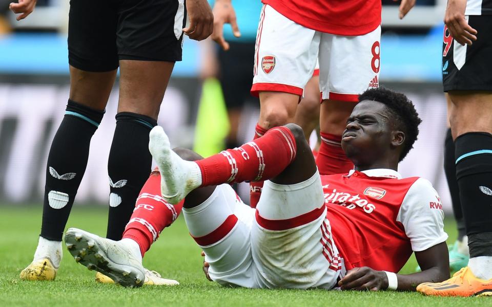 Bukayo Saka down in the second half at Newcastle - Shutterstock/Peter Powell