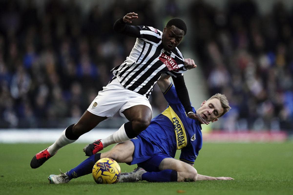 Jack Currie (right) makes a tackle for AFC Wimbledon <i>(Image: Jordan Pettitt/ PA Wire)</i>