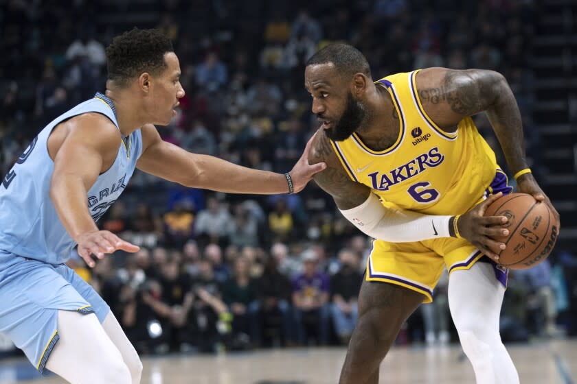 Memphis Grizzlies guard Desmond Bane (22) defends against Los Angeles Lakers forward LeBron James (6) during the first half of an NBA basketball game Wednesday, Dec. 29, 2021, in Memphis, Tenn. (AP Photo/Nikki Boertman)