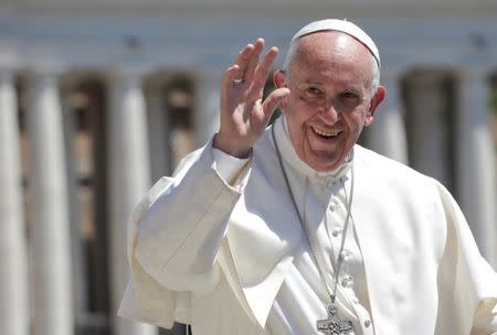 FILE PHOTO: Pope Francis waves as he leads the Wednesday General Audience in Saint Peter's square at the Vatican, May 17, 2017. REUTERS/Max Rossi