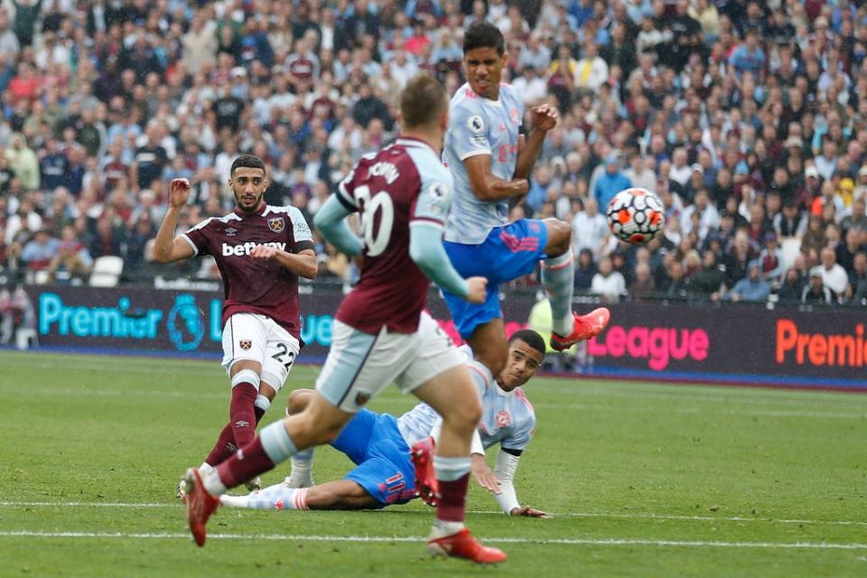 Algerian midfielder Said Benrahma (left) sees his shot deflected into the goal by Raphael Varane (right) (AFP/Getty)