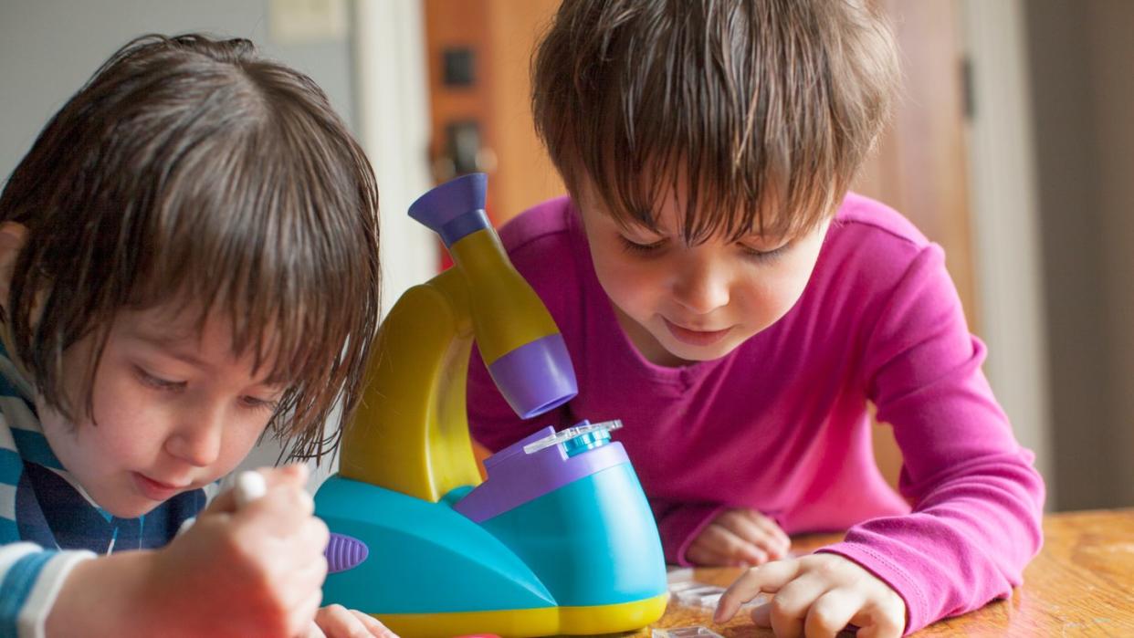 kids playing with toy microscope