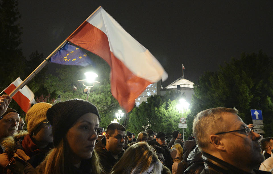 Demonstrators hold a rally to protest against changes to Poland's judiciary planned by the ruling Law and Justice party near the building of parliament in Warsaw, Poland, Wednesday, Dec. 18, 2019. (AP Photo/Czarek Sokolowski)