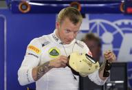 Lotus F1 Formula One driver Kimi Raikkonen of Finland wears his cap during the third practice session of the Italian F1 Grand Prix at the Monza circuit September 7, 2013. REUTERS/Max Rossi (ITALY - Tags: SPORT MOTORSPORT F1)