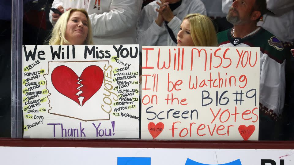 Arizona Coyotes fans in the crowd hold signs for the players following the game against the Edmonton Oilers at Mullett Arena. - Mark J. Rebilas/USA TODAY Sports/Reuters