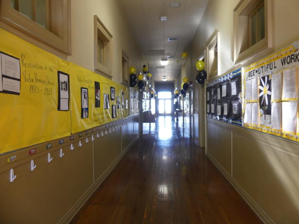 The hallway walls showcase the "100-Year Anniversary Timeline" of the Sixth Street Prep building located in downtown Victorville.