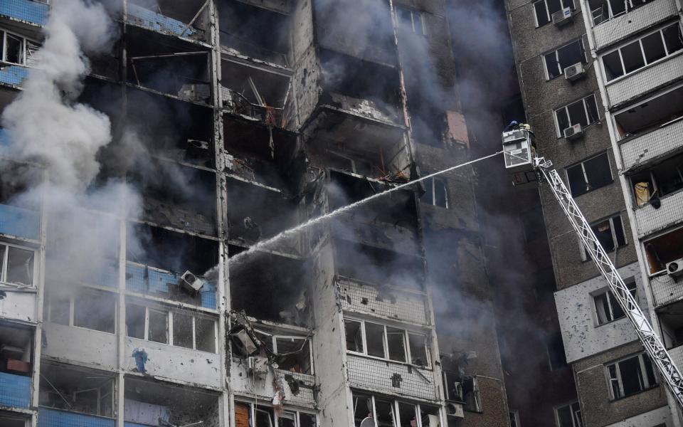 Ukrainian rescuers extinguish a fire in a residential building in Kyiv