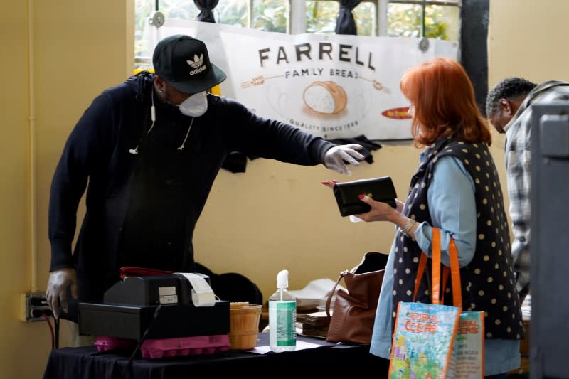 Vendor McIver gives change back to a customer at the Farmers Public Market in Oklahoma City