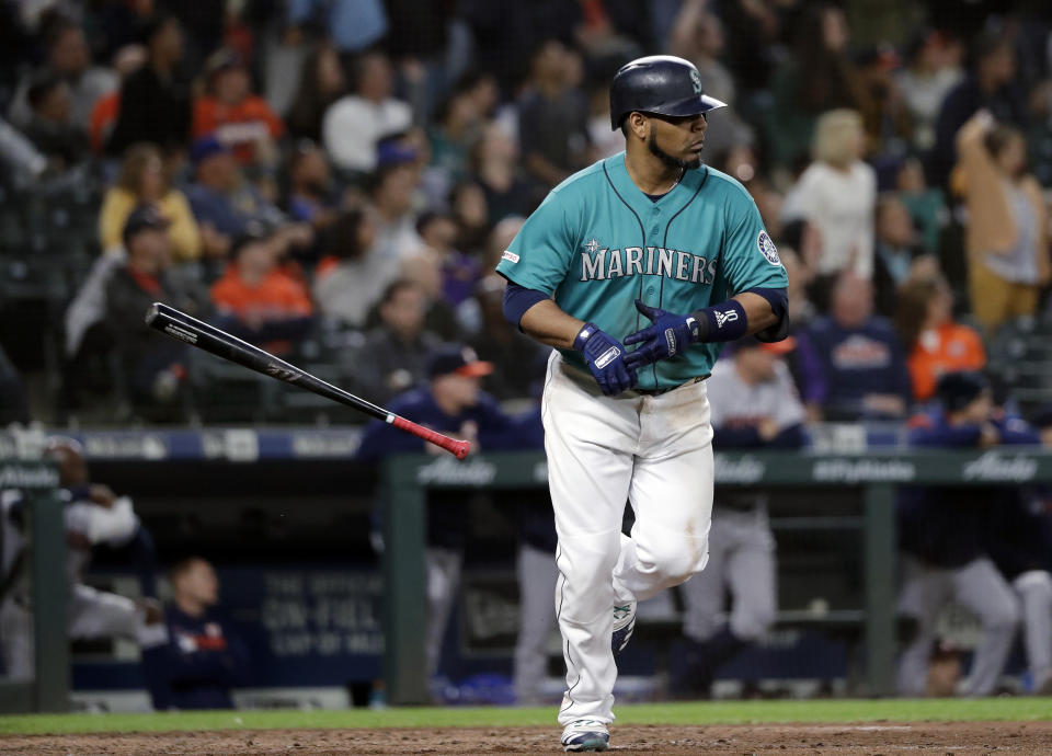 Seattle Mariners' Edwin Encarnacion tosses aside his bat after hitting a three-run home run against the Houston Astros durng the sixth inning of a baseball game Wednesday, June 5, 2019, in Seattle. (AP Photo/Elaine Thompson)
