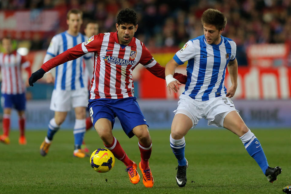 Atletico's Diego Costa, left, in action with Real Sociedad's Jon Gaztanaga, right, during a Spanish La Liga soccer match between Atletico de Madrid and Real Sociedad at the Vicente Calderon stadium in Madrid, Spain, Sunday, Feb. 2, 2014. (AP Photo/Andres Kudacki)