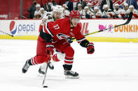 Carolina Hurricanes' Andrei Svechnikov (37) brings the puck up the ice after taking it away from Florida Panthers' Kevin Connauton (44) during the second period of an NHL hockey game in Raleigh, N.C., Sunday, March 7, 2021. (AP Photo/Karl B DeBlaker)