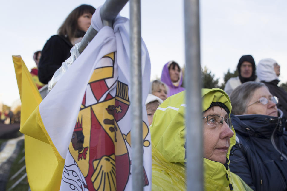 Faithful gather to follow Pope Francis' celebrating Holy Mass at the Confluence Park in Kaunas, Lithuania, Sunday, Sept. 23, 2018. Pope Francis is on the second of his two-day visit to Lithuania. (AP Photo/Mindaugas Kulbis)