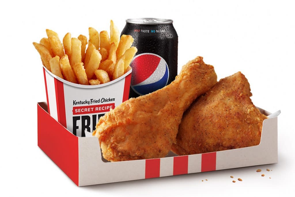 Chicken is photographed with fries and a beverage at KFC.