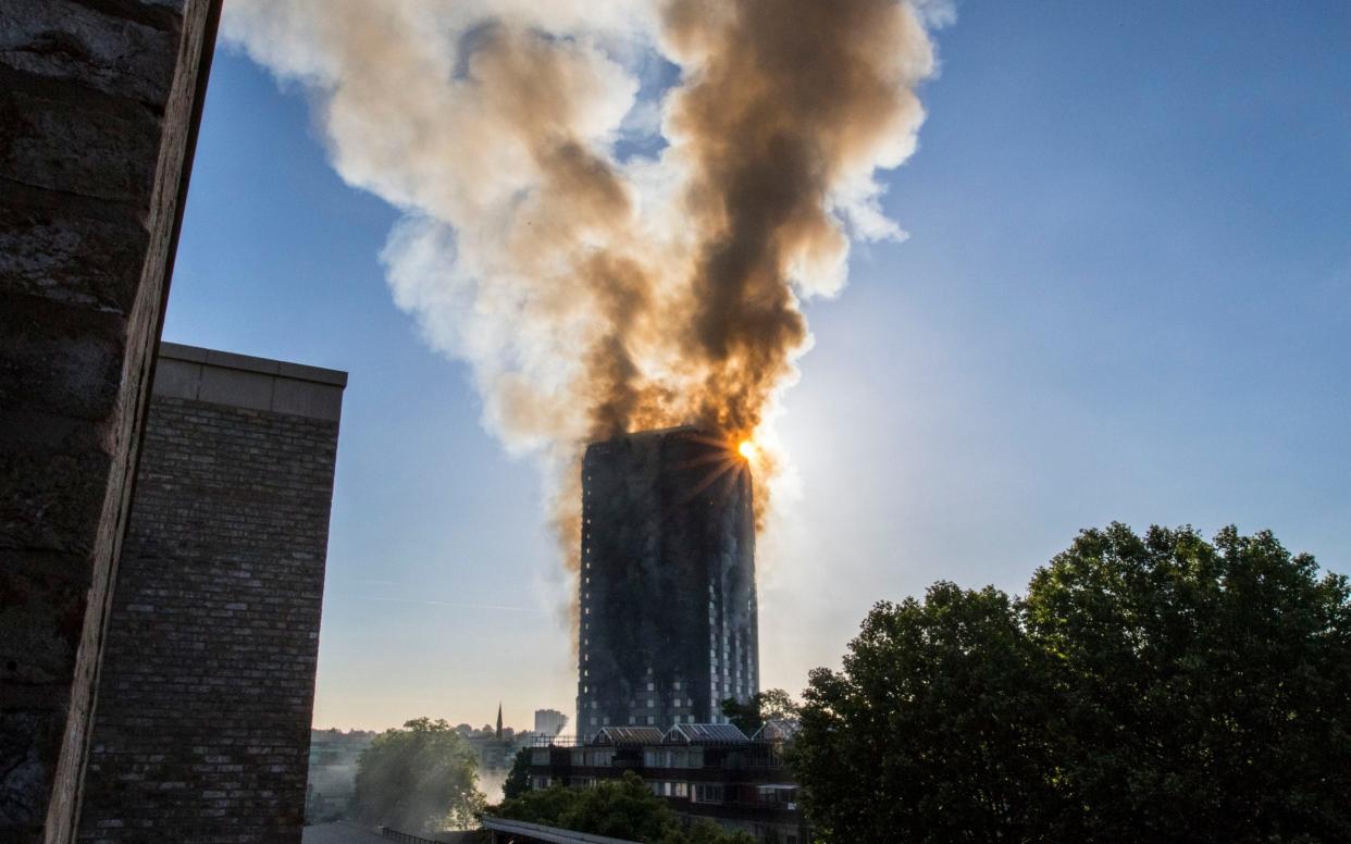 Smoke billows from a fire that has engulfed the 27-storey Grenfell Tower in west London - PA