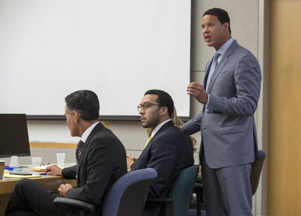 Brian Watkins, right, an attorney for former NFL football player Kellen Winslow Jr., puts his hands on Winslow as he gives his opening statement to the jury during Winslow's rape trial, Monday May 20, 2019, in Vista, Calif. (John Gibbins/The San Diego Union-Tribune via AP, Pool)