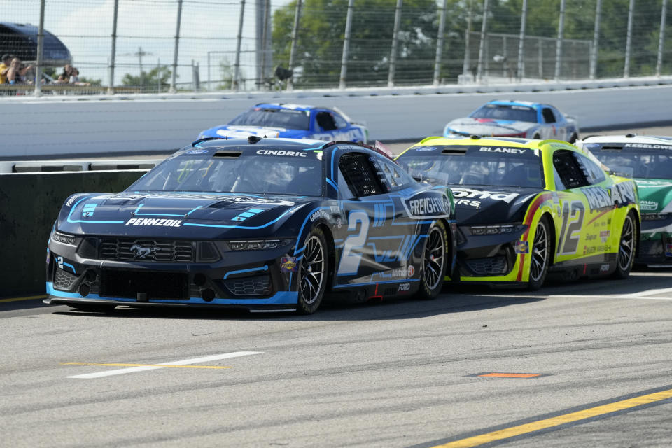 Austin Cindric (2) drives down pit lane followed by Ryan Blaney (12) during a NASCAR Cup Series auto race at World Wide Technology Raceway Sunday, June 2, 2024, in Madison, Ill. (AP Photo/Jeff Roberson)
