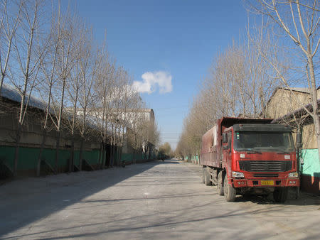 A truck pulls up beside a ceramics factory in Zibo, Shandong province, China November 23, 2017. Picture taken November 23, 2017. REUTERS/David Stanway