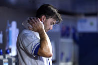 New York Mets starting pitcher David Peterson puts ice on his neck during the fifth inning of a baseball game against the Miami Marlins, Sunday, June 26, 2022, in Miami. The Marlins won 3-2. (AP Photo/Lynne Sladky)