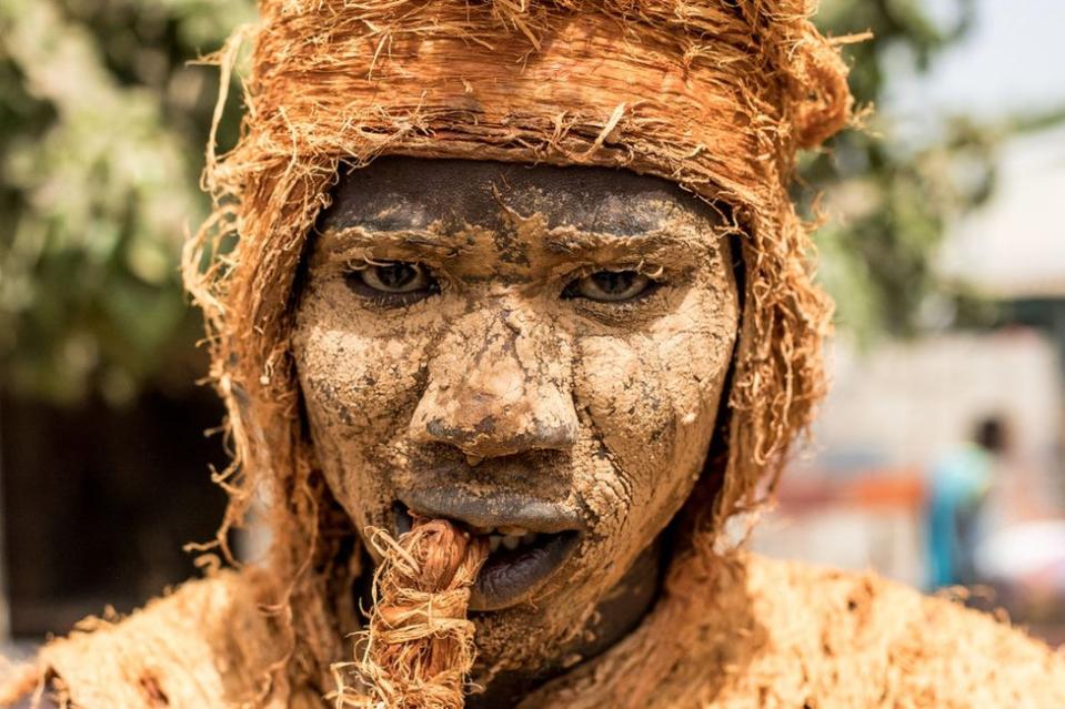 A man wears a traditional kankurang mask during the kankurang Festival in Janjanbureh on January 27, 2024. Listed as a UNESCO World Heritage Site since 2005, Kankurang, a combination of the Mandingo words "kango" and "Kurango", literally translated as "voice" and "force", ensures the transmission and teaching of the values and practices that form the basis of Mandingo cultural identity, a West African people whose historical home was the Mali empire