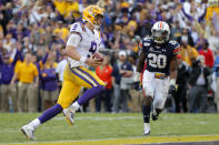 LSU quarterback Joe Burrow (9) carries for a touchdown in front of Auburn defensive back Jeremiah Dinson (20) in the second half of an NCAA college football game in Baton Rouge, La., Saturday, Oct. 26, 2019. (AP Photo/Gerald Herbert)