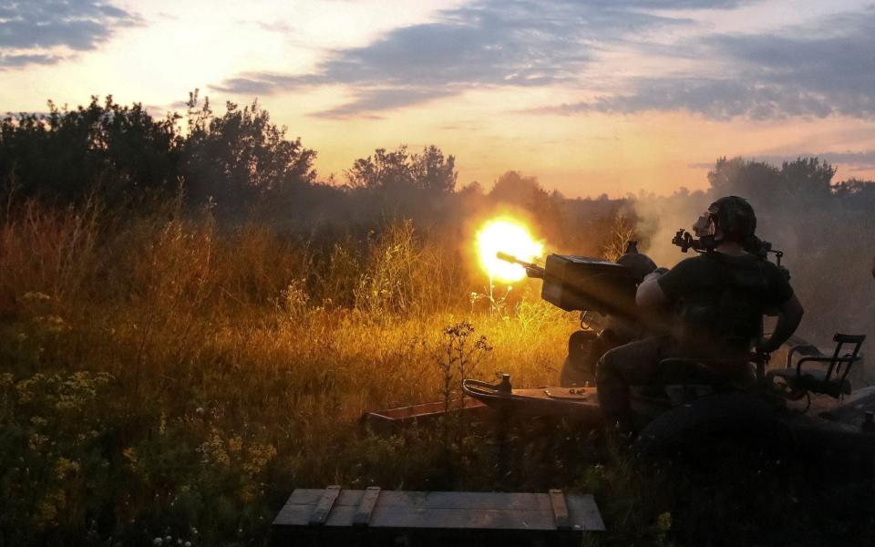 Ukrainian serviceman fires a ZU-23-2 anti-aircraft cannon near the Kharkiv frontline - VYACHESLAV MADIYEVSKYY/REUTERS