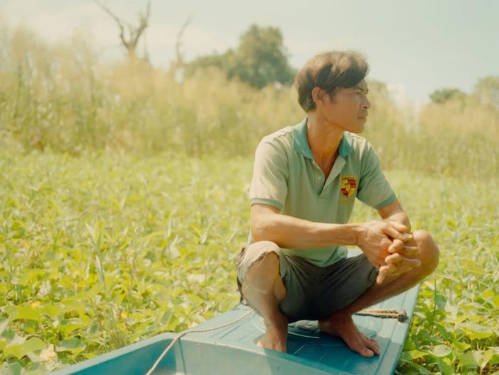 Lim Ny on his boat in the backyard of his home, Phat Sanday floating village (1854 x WaterAid: Once Beating Heart ©Calvin Chow 2022)