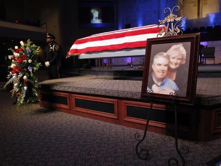 A photograph is displayed at a memorial service for Kaufman County district attorney Mike McLelland and his wife Cynthia in Sunnyvale, Texas April 4, 2013. REUTERS/Mike Stone