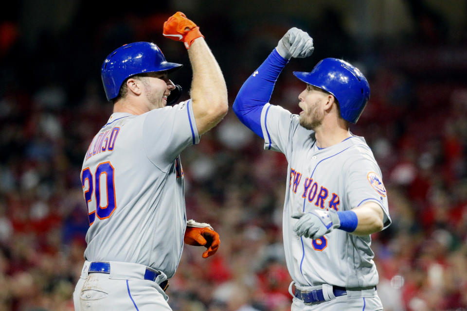 New York Mets' Pete Alonso, left, celebrates with Jeff McNeil, right, after hitting a two-run home run off Cincinnati Reds starting pitcher Sal Romano in the eighth inning of a baseball game Friday, Sept. 20, 2019, in Cincinnati. (AP Photo/John Minchillo)