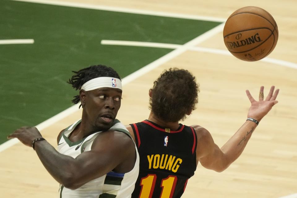 Atlanta Hawks' Trae Young steals the ball from Milwaukee Bucks' Jrue Holiday during the first half of Game 2 of the NBA Eastern Conference basketball finals game Friday, June 25, 2021, in Milwaukee. (AP Photo/Morry Gash)