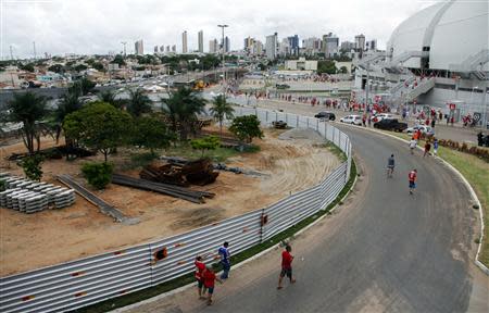 Soccers fans arrive to attend a local match at the Arena das Dunas stadium, in Natal May 10, 2014. REUTERS/Nuno Guimaraes